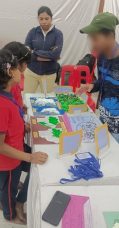 children explaining their project to other children